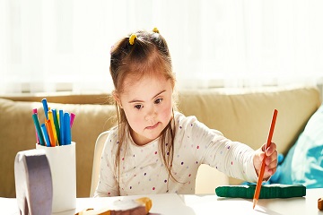 A girl drawing a picture. 