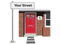 Front door of a house with a street sign
