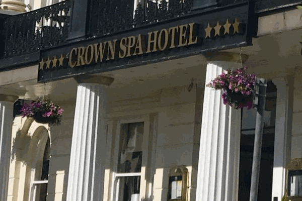Crown Spa Hotel sign outside entrance.