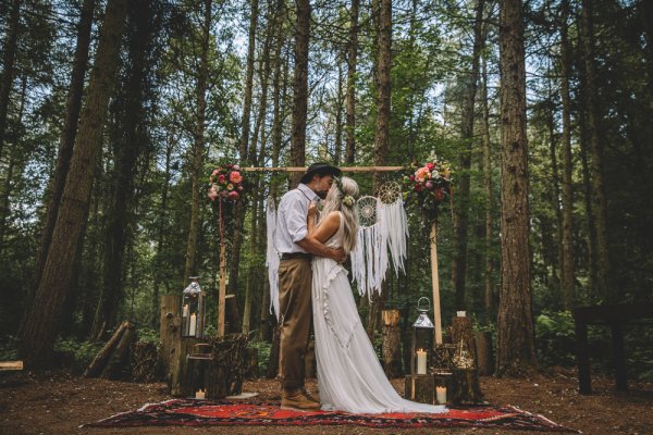 A couple kiss in this photo promoting Free Spirit weddings at Camp Hill Estate.