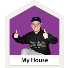 Boy with two thumbs up in a house