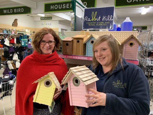 Two Ridings Community Foundation members standing together holding bird boxes.