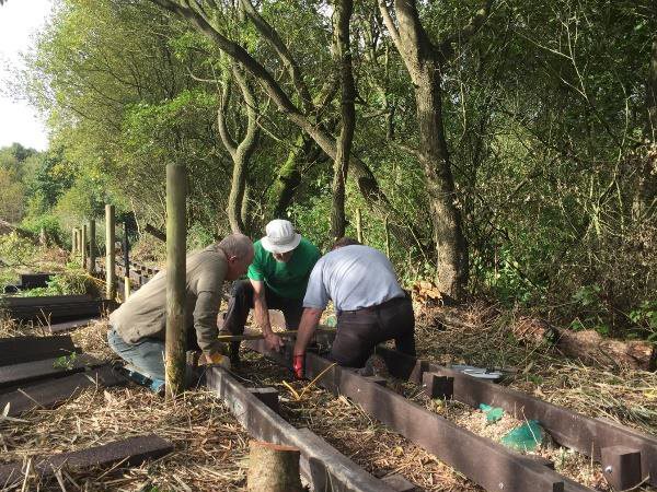 Volunteers helping to set up boardwalk used to cross fields without getting mud and dirt everywhere