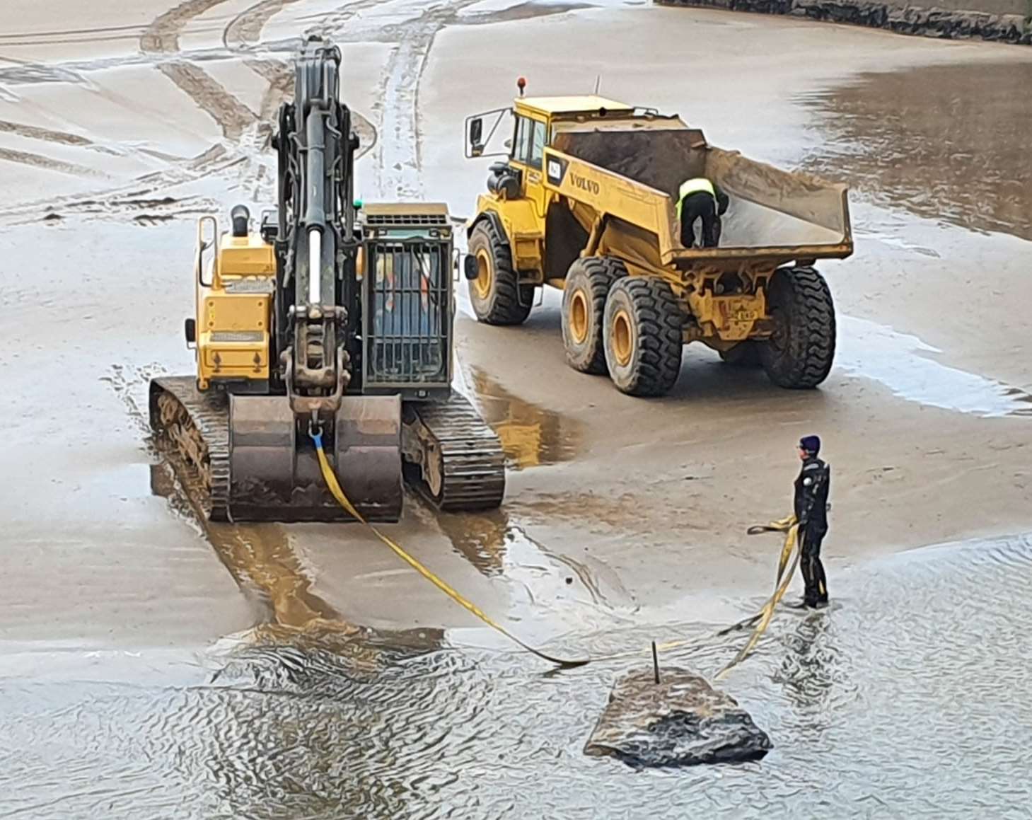 Removing a large stone from the seabed.