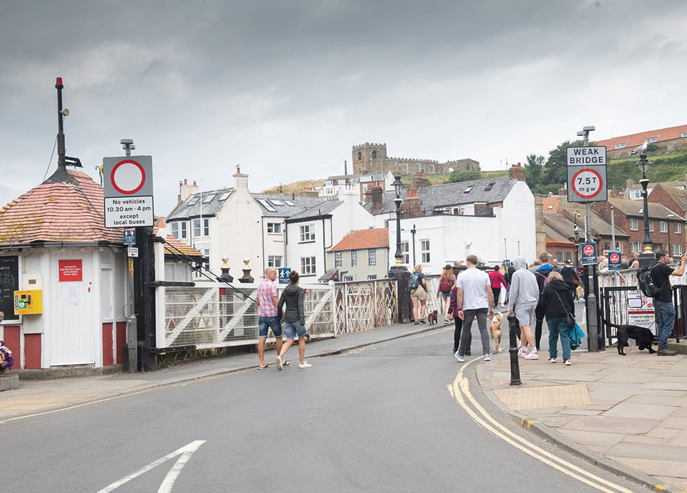 People walking over Whitby Swing Bridge