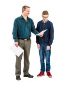 A man and a boy reading some papers.