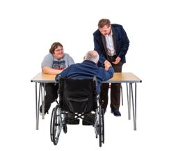 A person in a wheelchair with two other people