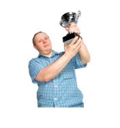 A man holding up a trophy.