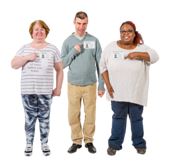 Three volunteers with name badges standing in a row.