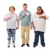 Three volunteers with  name badges standing in a row.