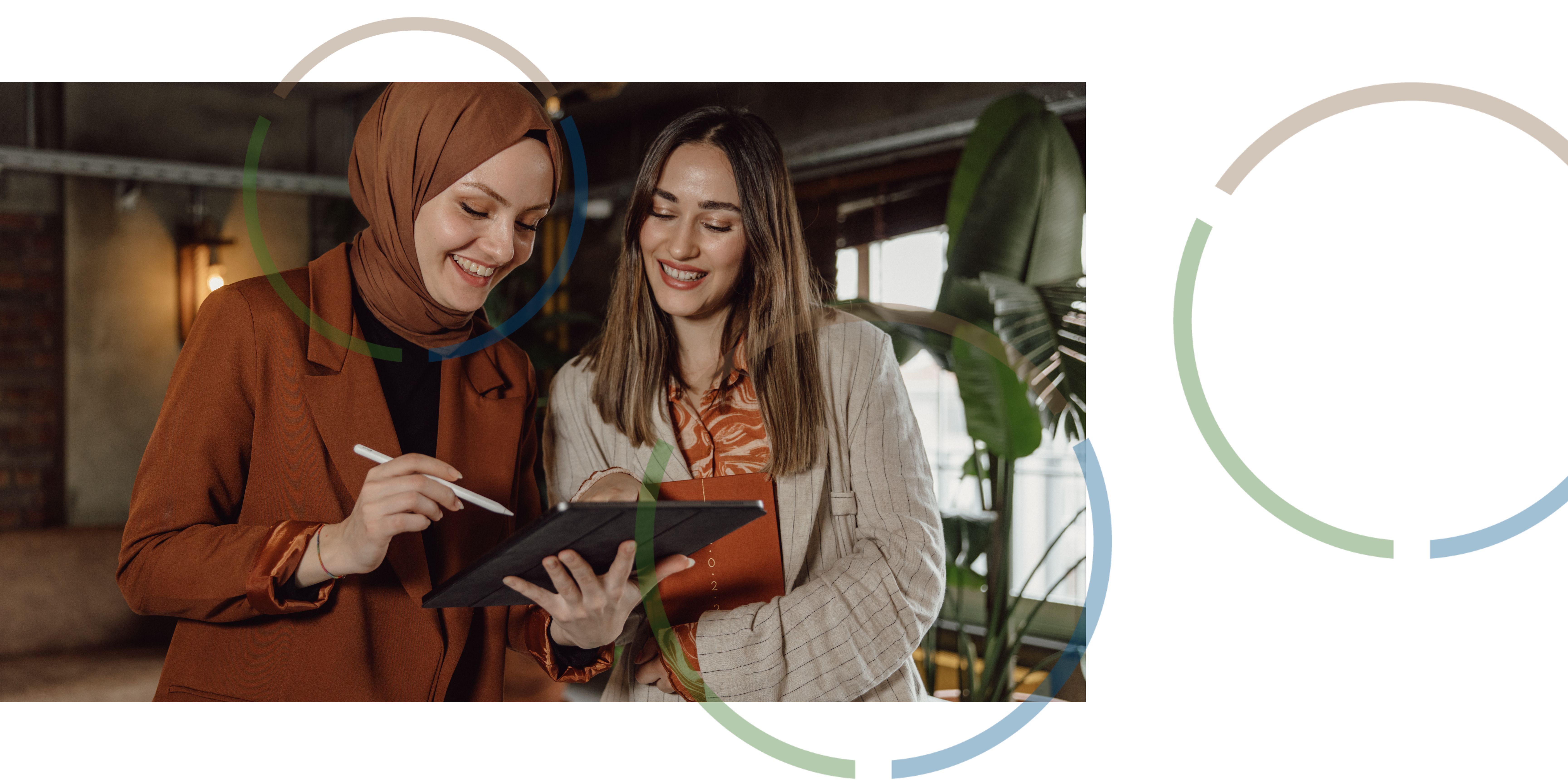 Two women looking at a tablet.