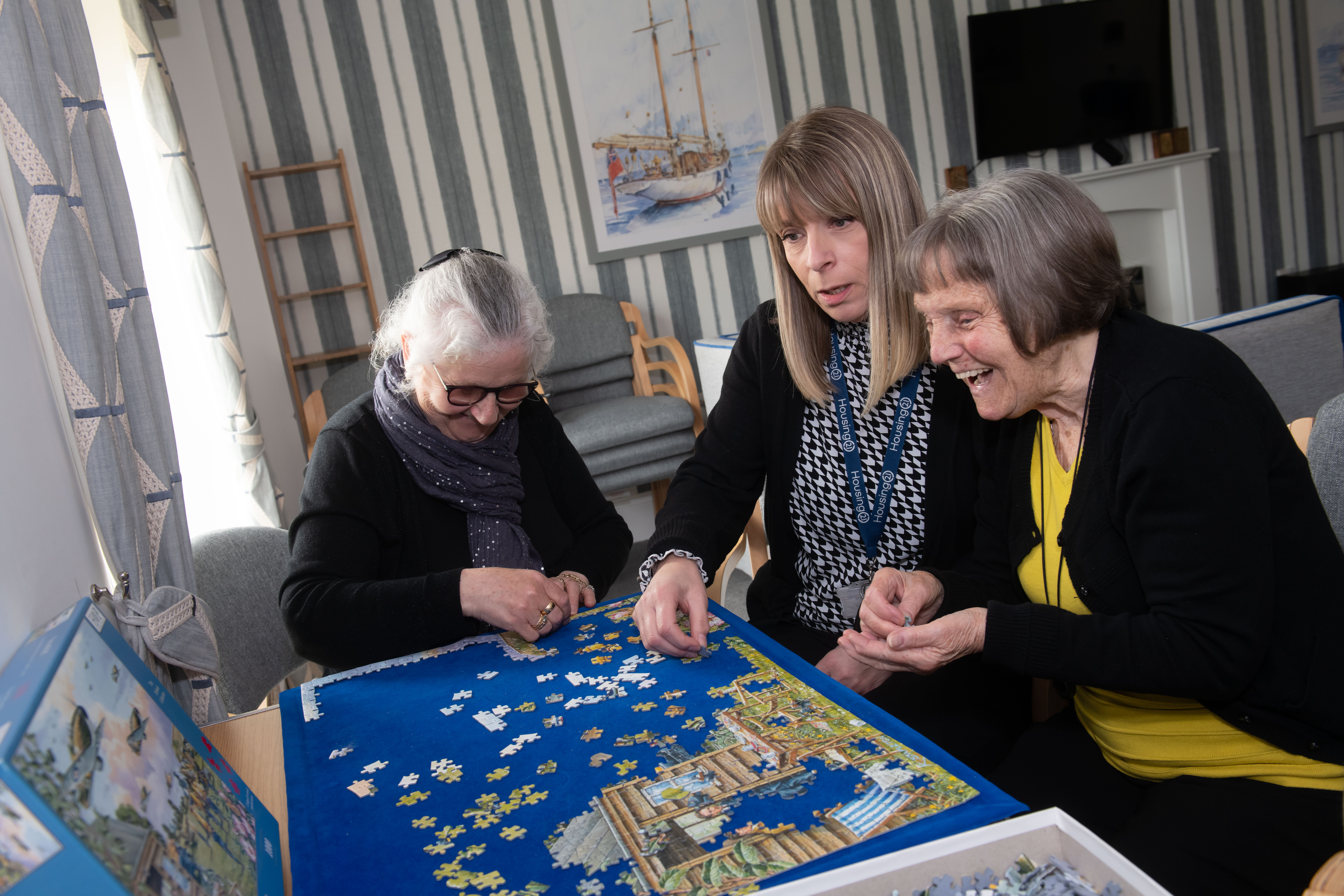 Three ladies doing a jigsaw