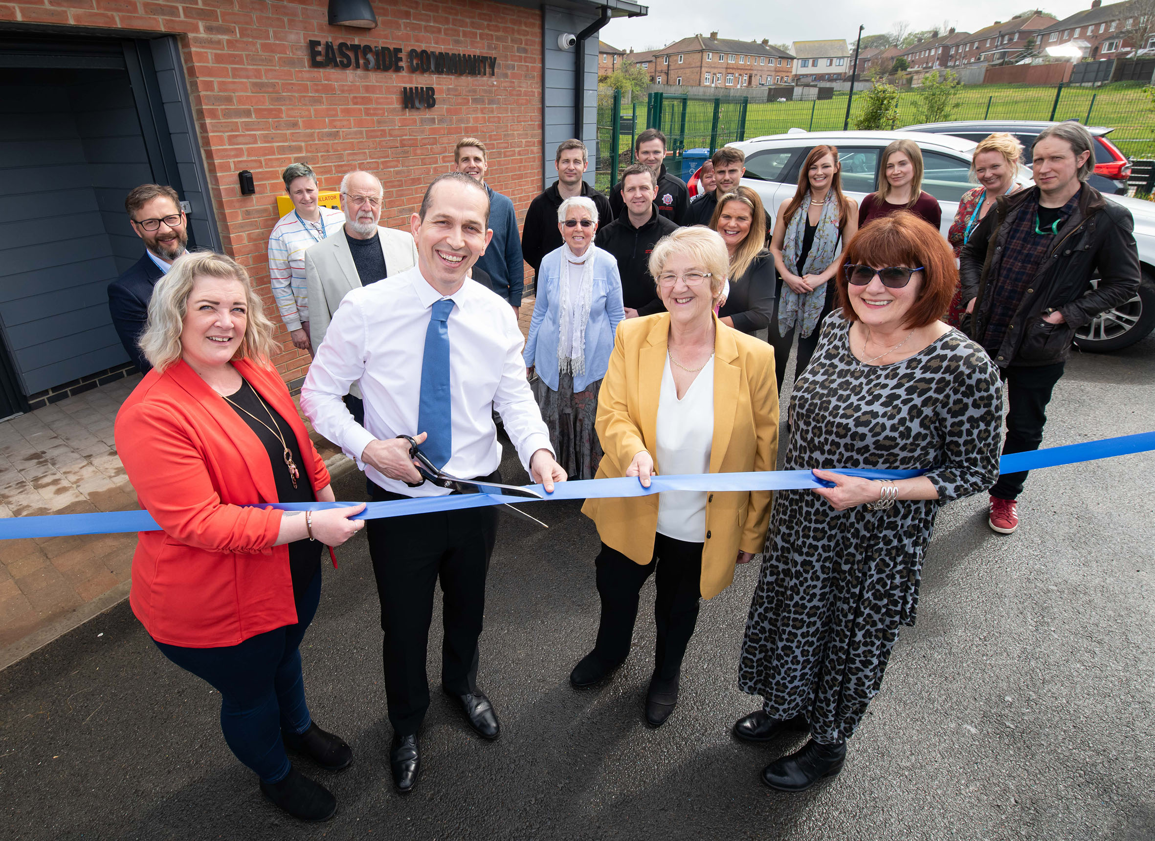 Cutting the ribbon at the opening of Eastside Community Hub