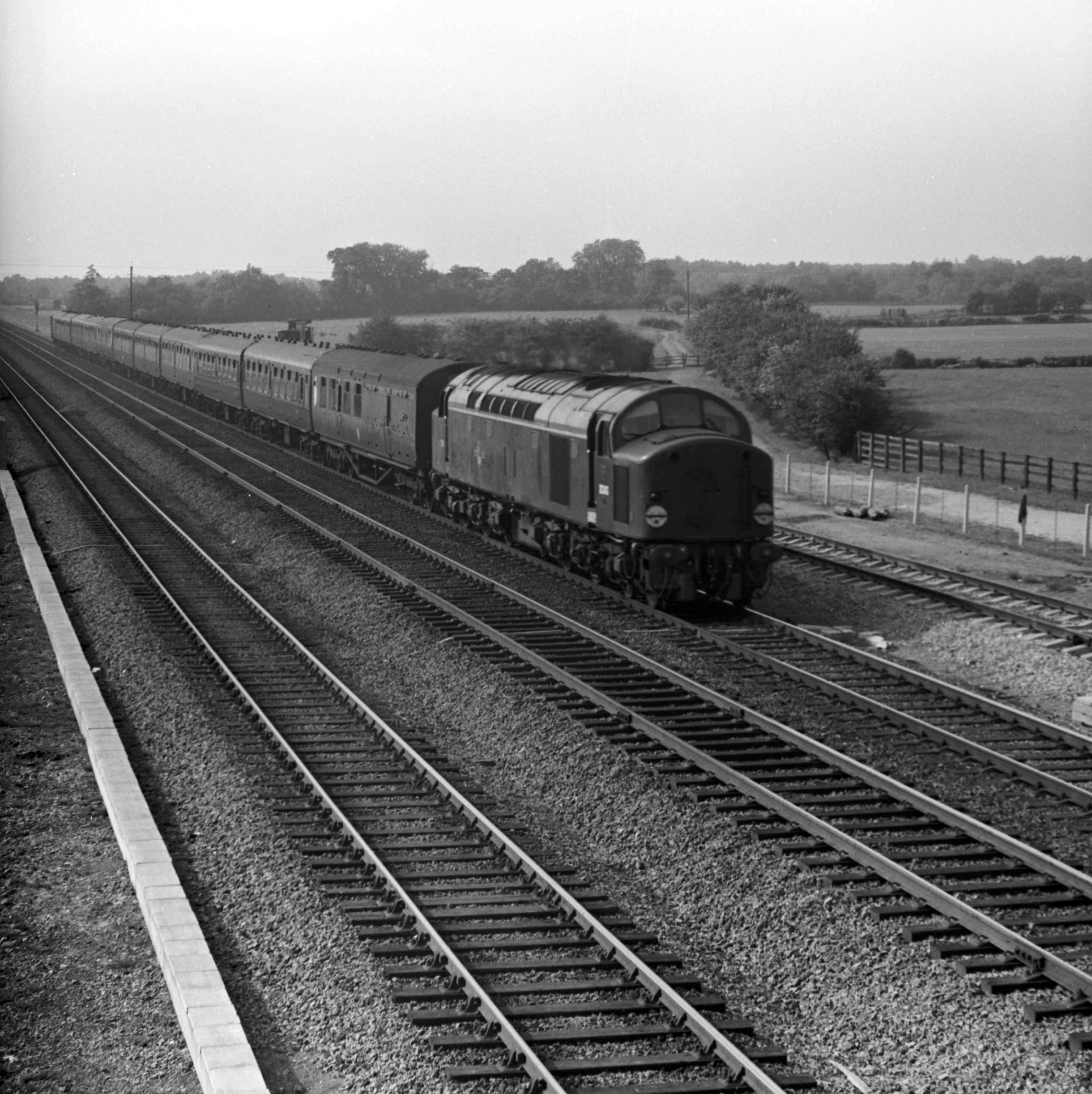•	A passenger train travels along the main East Coast railway line at Pilmoor.