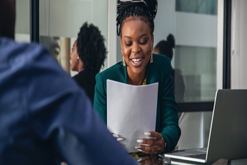 A woman smiling in an office.