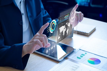 Hands controlling a hologram showing graphs. 