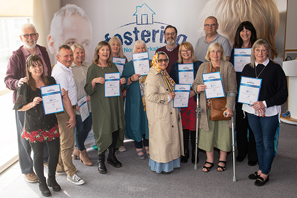 A group of people holding their fostering certificates