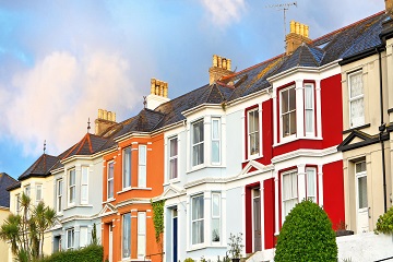A row of terraced houses with bay windows.