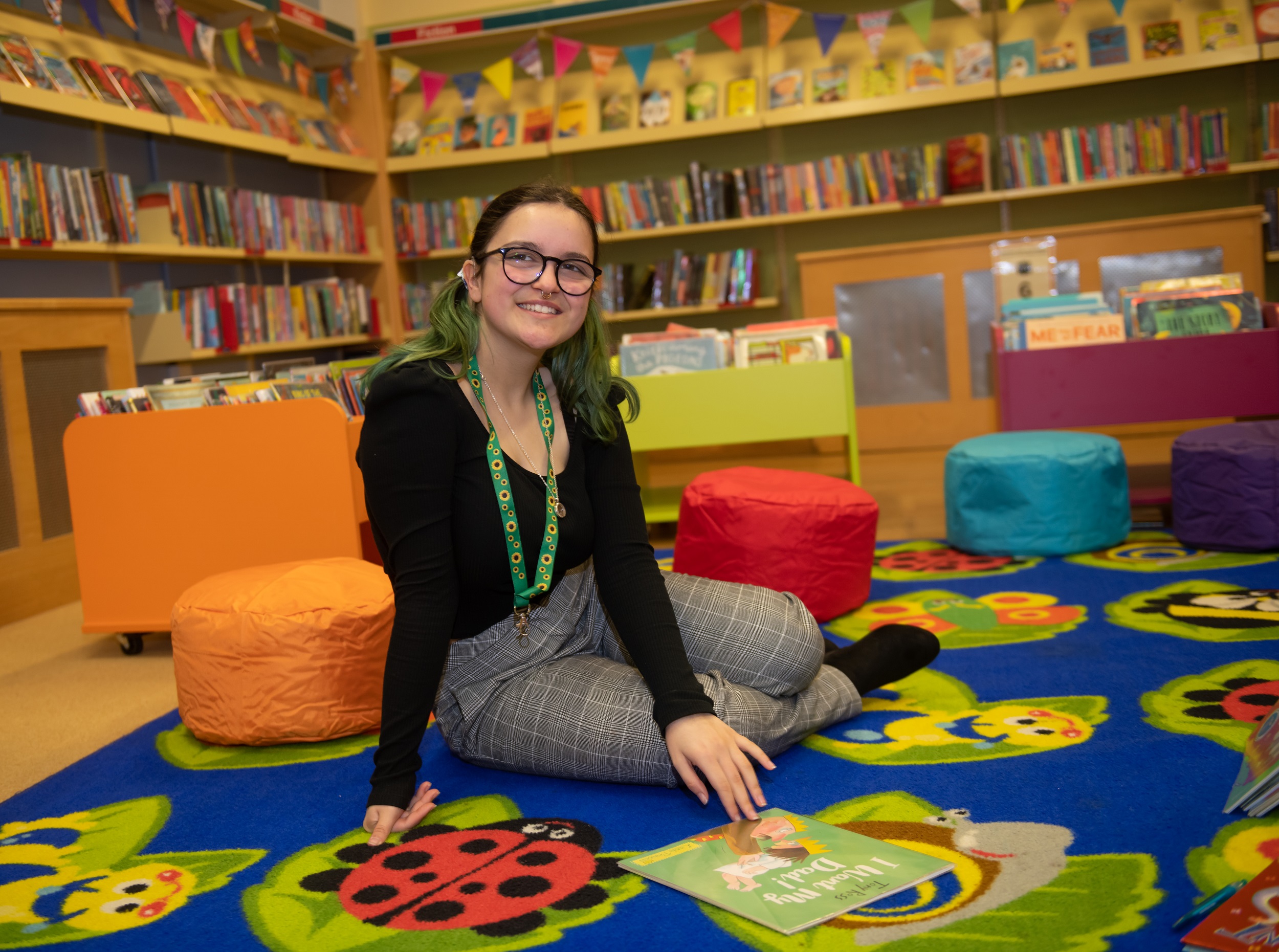A library volunteer sat in a library