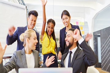 Co-workers celebrating together in an office.