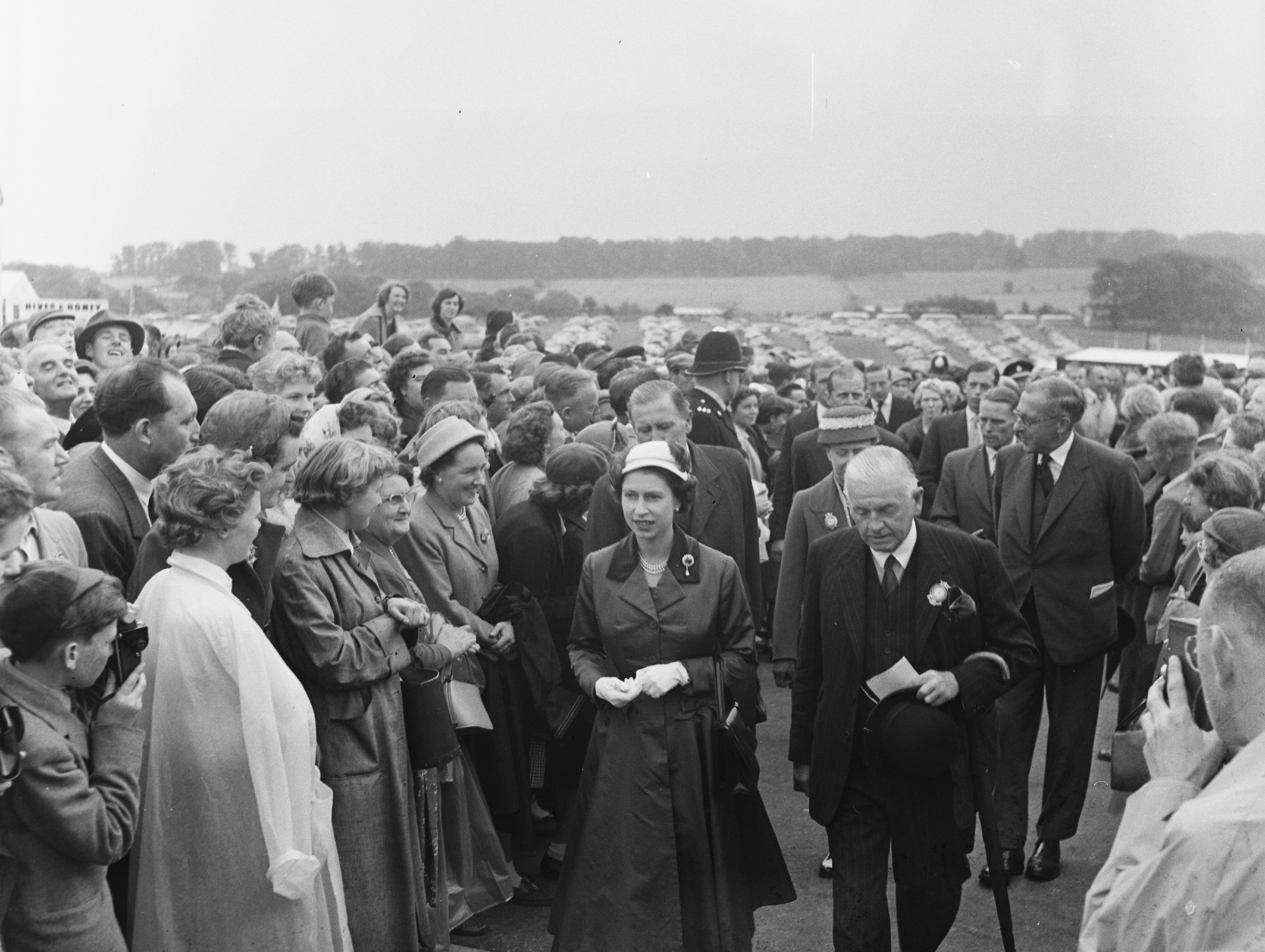 Queen Elizabeth II is shown around the Great Yorkshire Show by the show's president, Lieutenant Colonel Sir John Dunnington-Jefferson, in 1957.