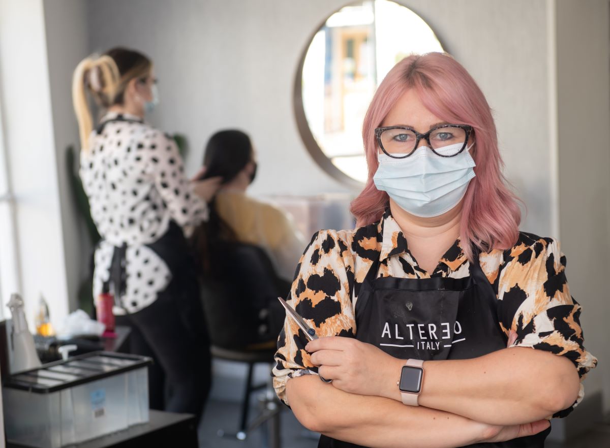 A woman wearing a medical mask in a hair salon