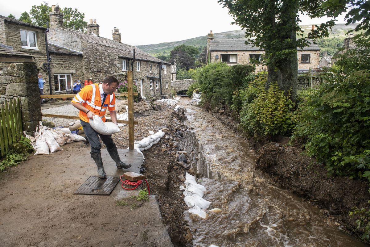 A man building flood defences