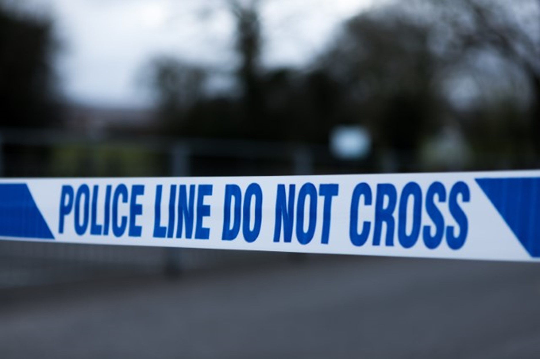 An emergency scene with a cordon stating 'Police Line, Do Not Cross'.