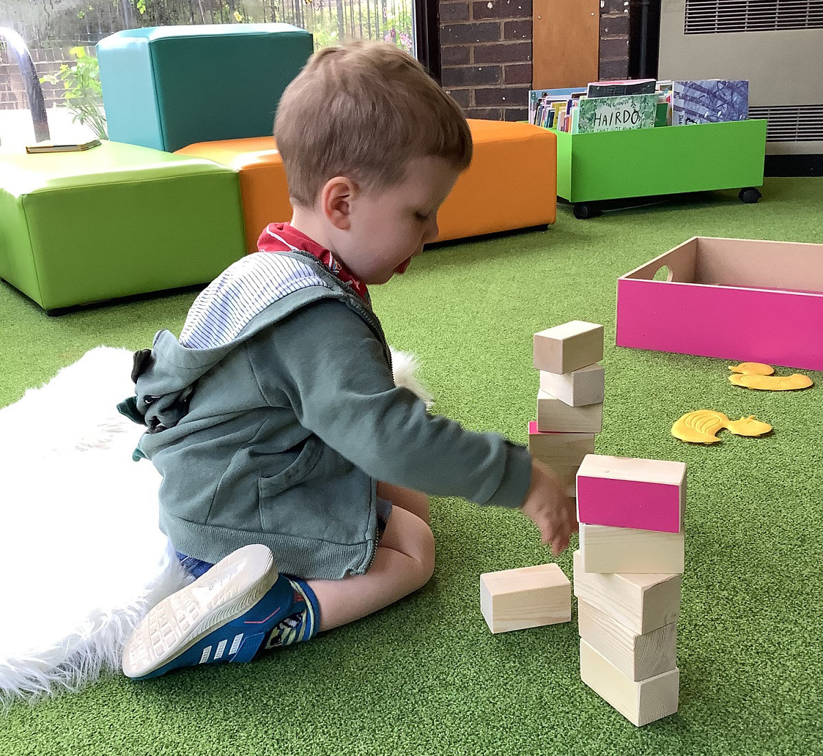 A young boy playing with blocks