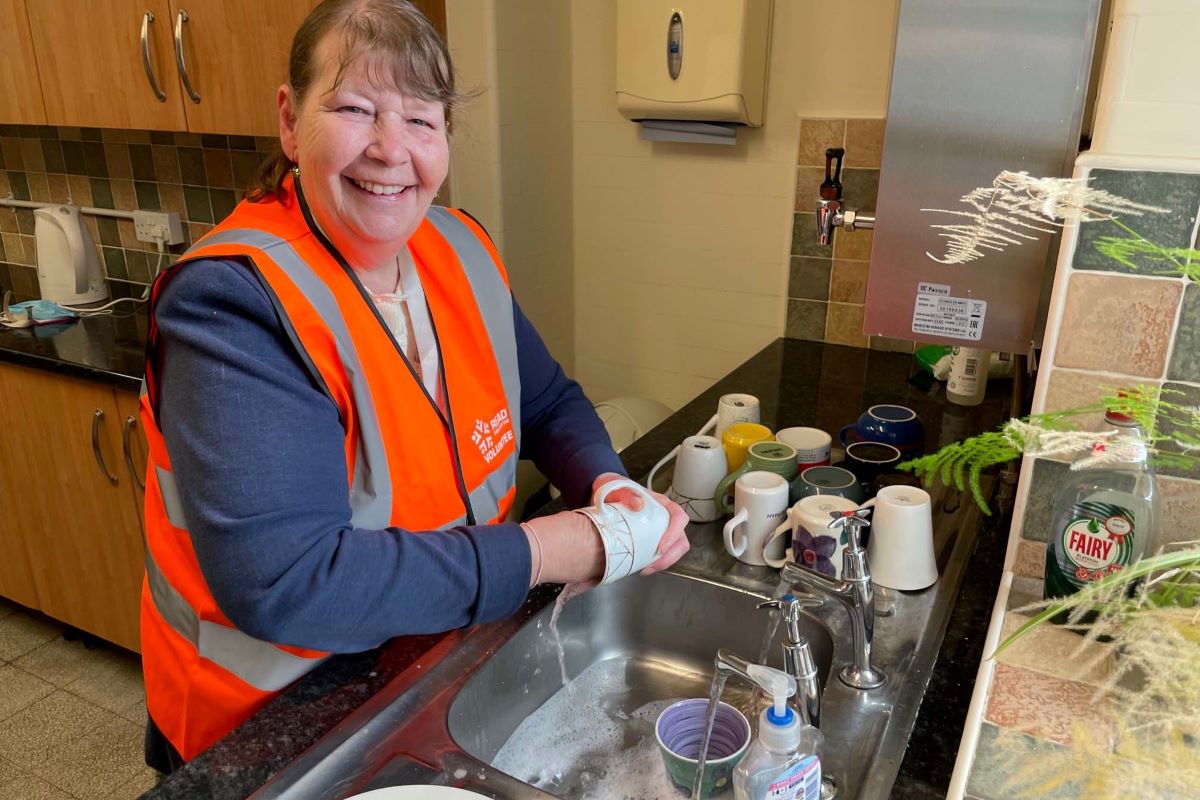 A volunteer washing up