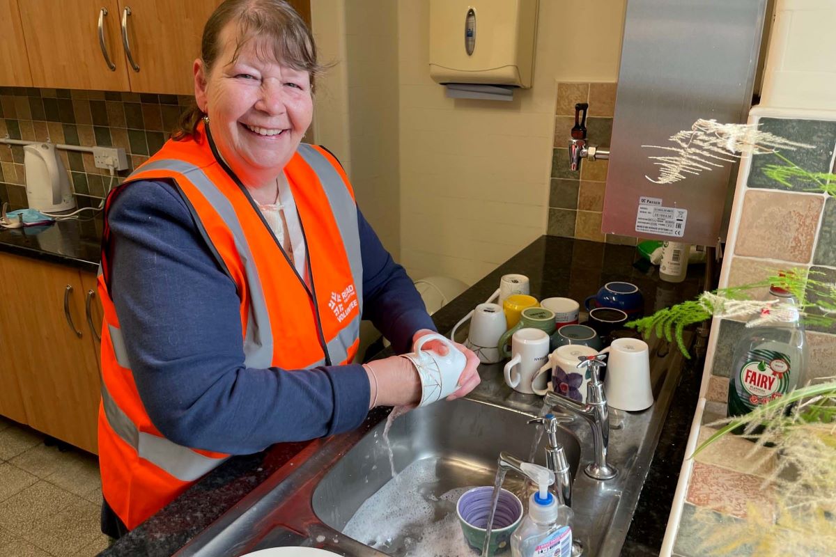 A volunteer washing up