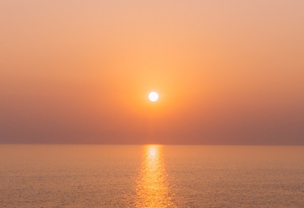 A sunset over a calm sea