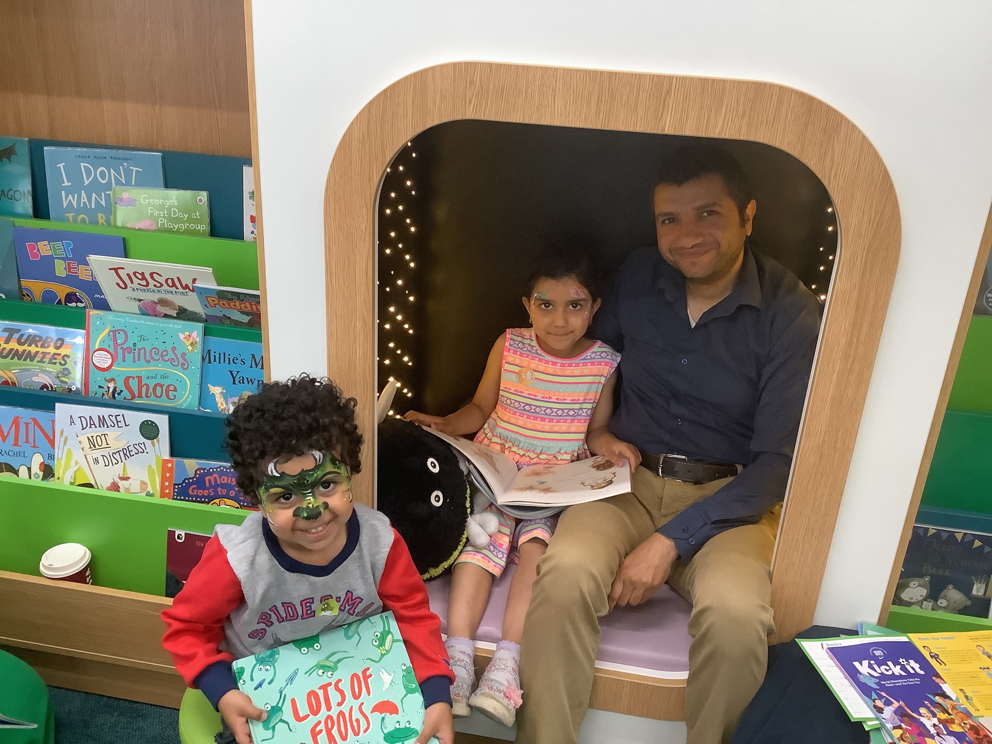 3 children reading in the library