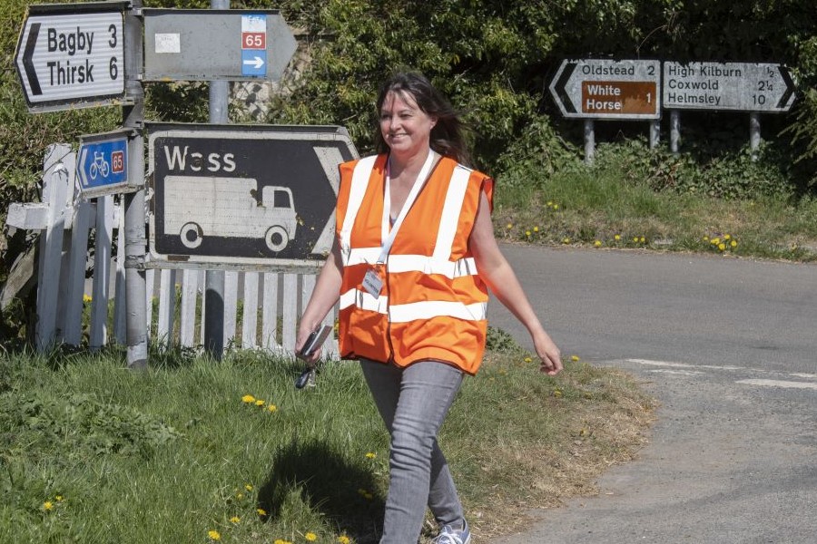 A volunteer wearing an orange vest helping during the COVID-19 epidemic.