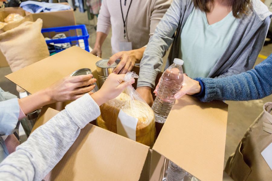 Volunteers packing up food parcel boxes