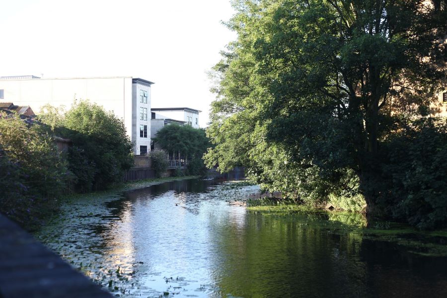 A slow moving river running through a town