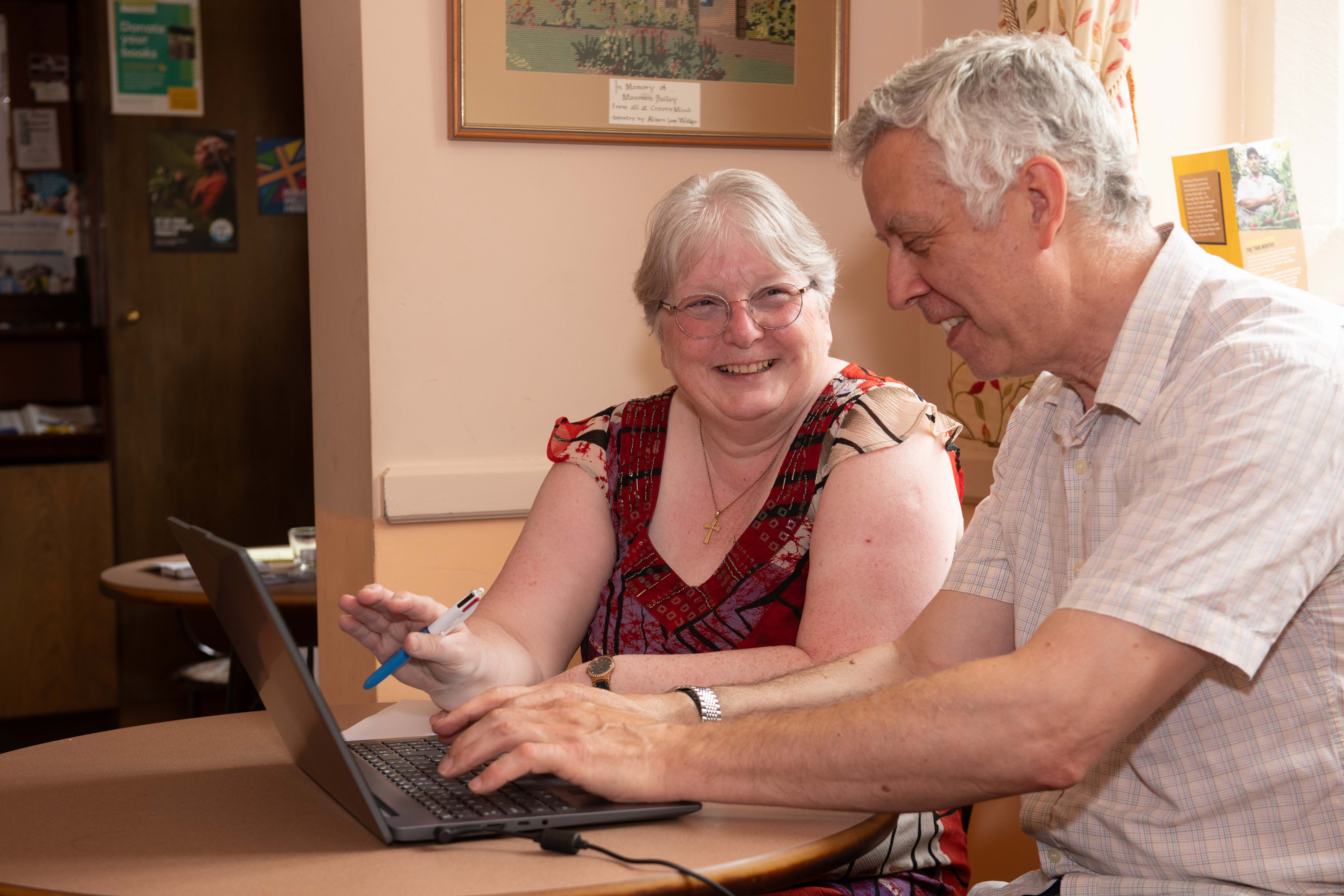 A lady and man using a laptop