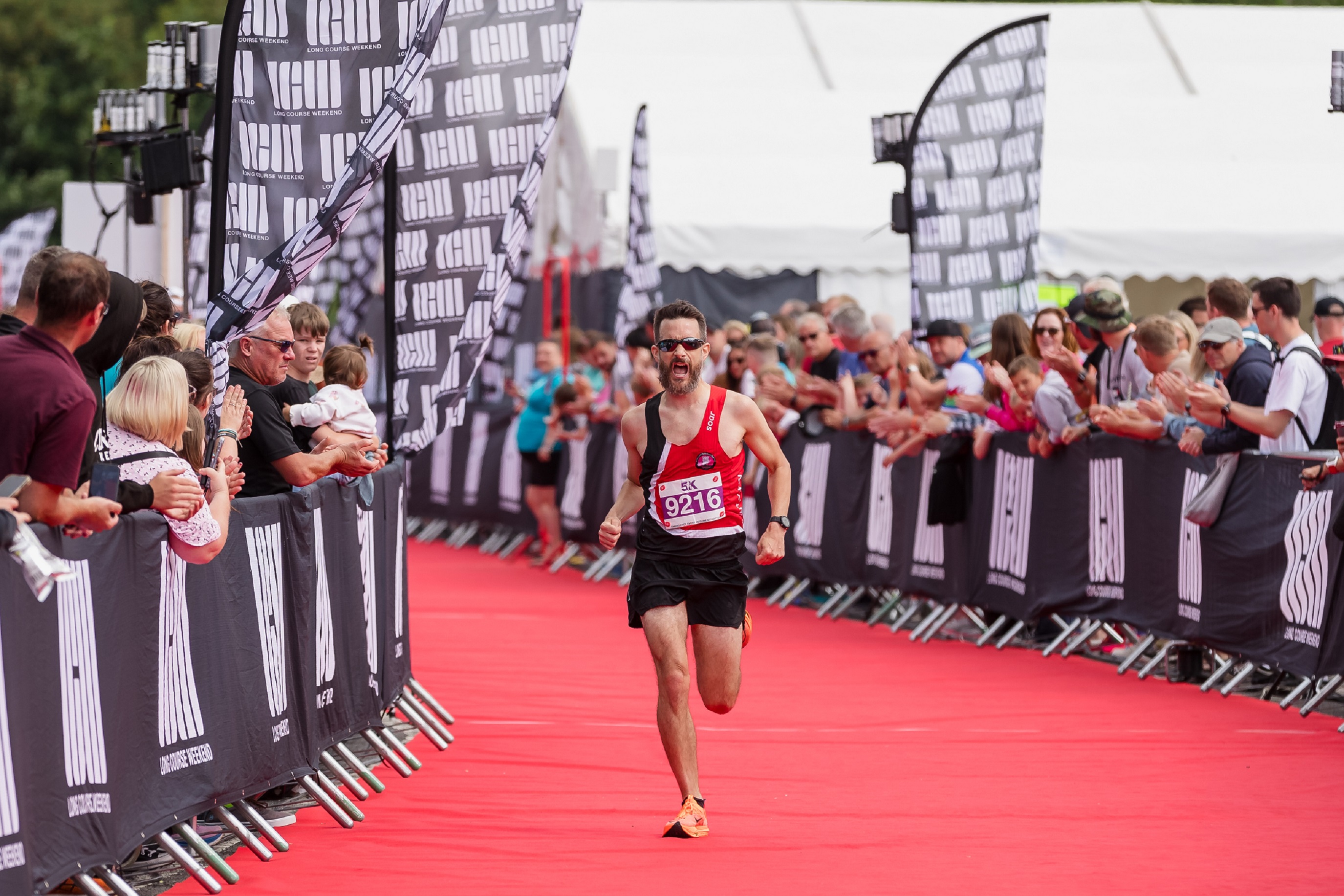 A runner watched by spectators