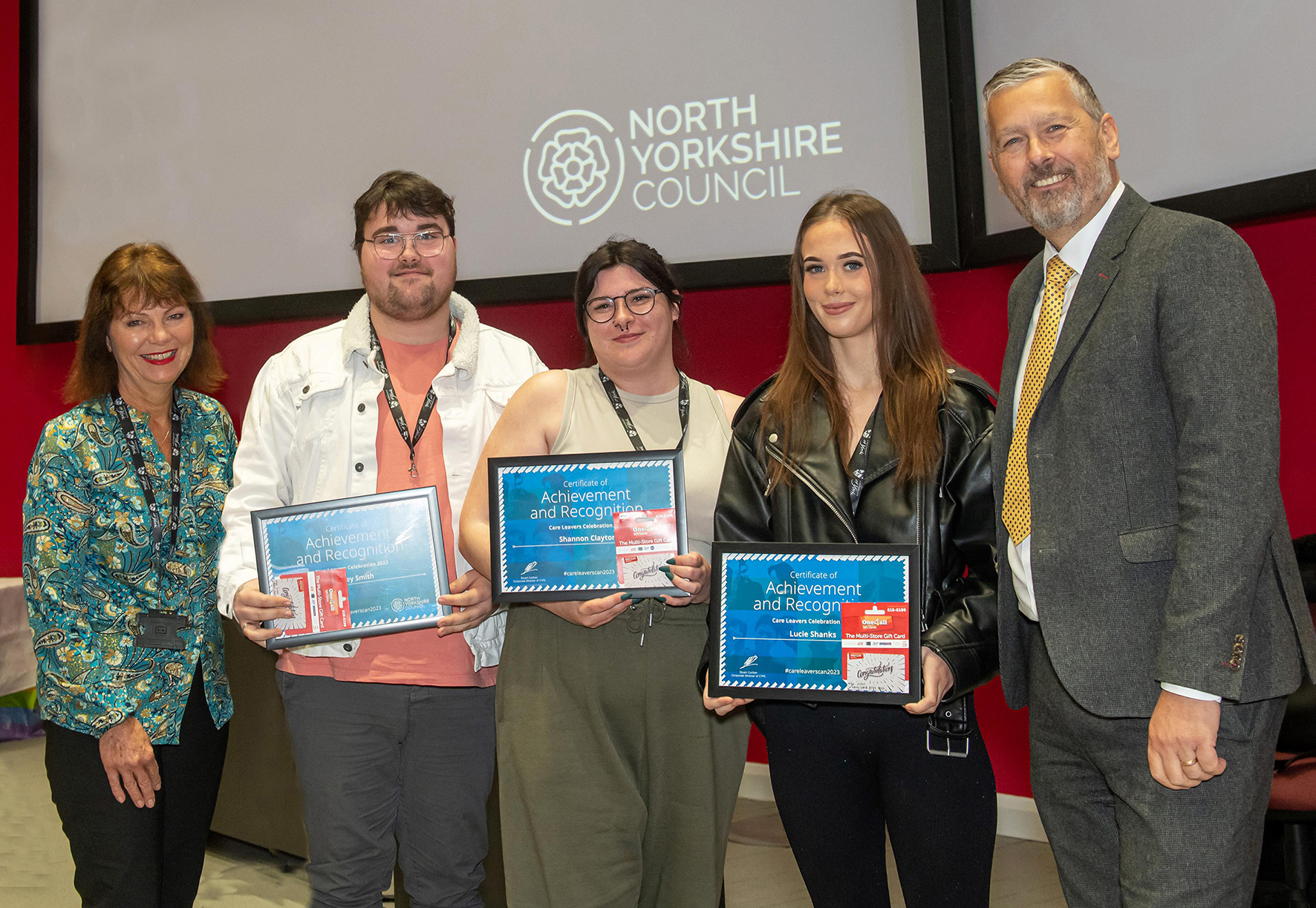 Young people holding their awards