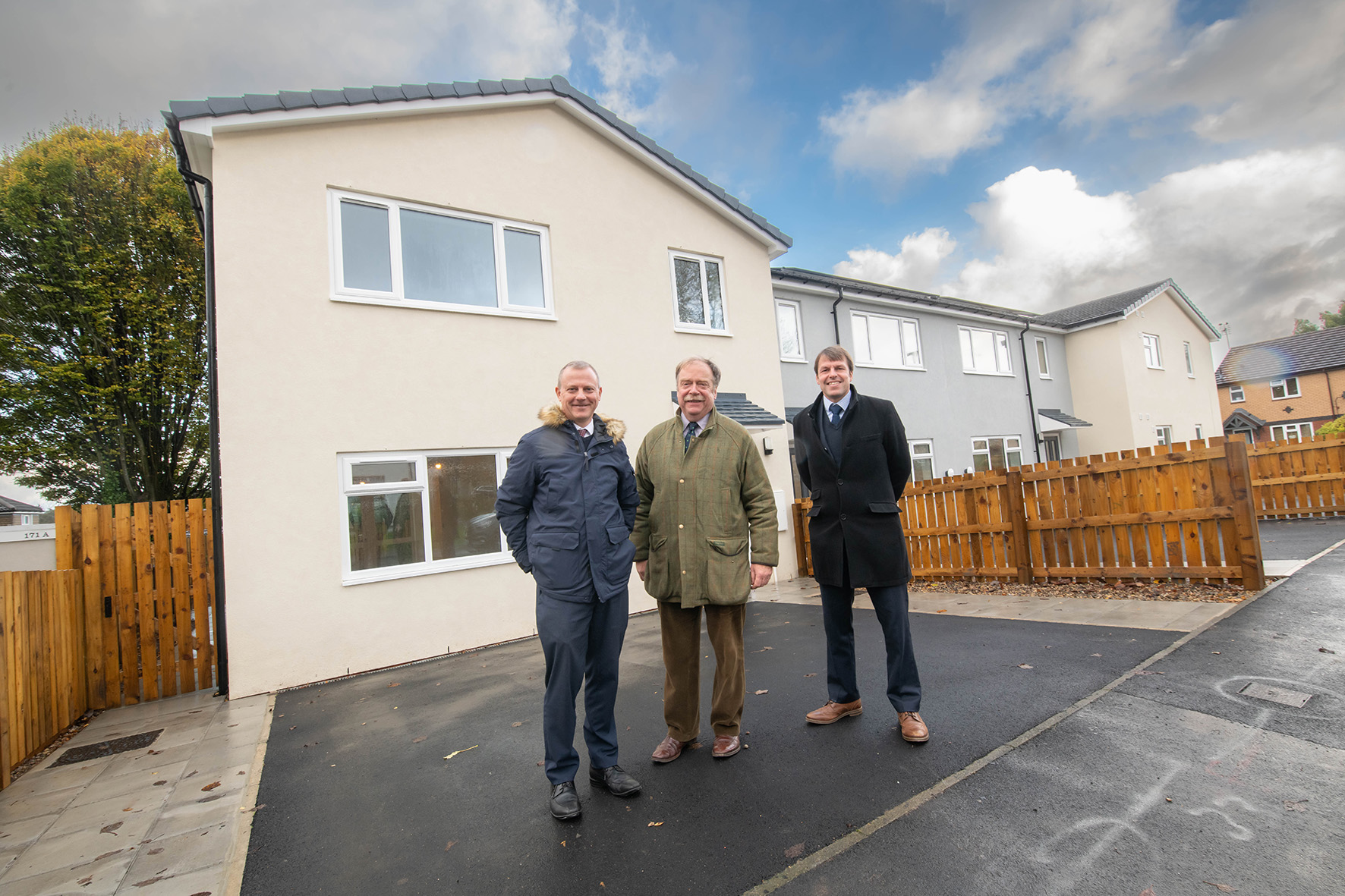 North Yorkshire councillor Simon Myers (centre) outside the new Harrogate homes.