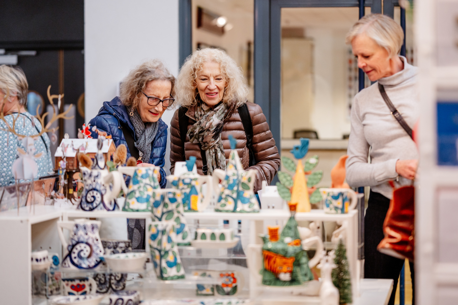 People looking at a stall at the Country Living Christmas Fair