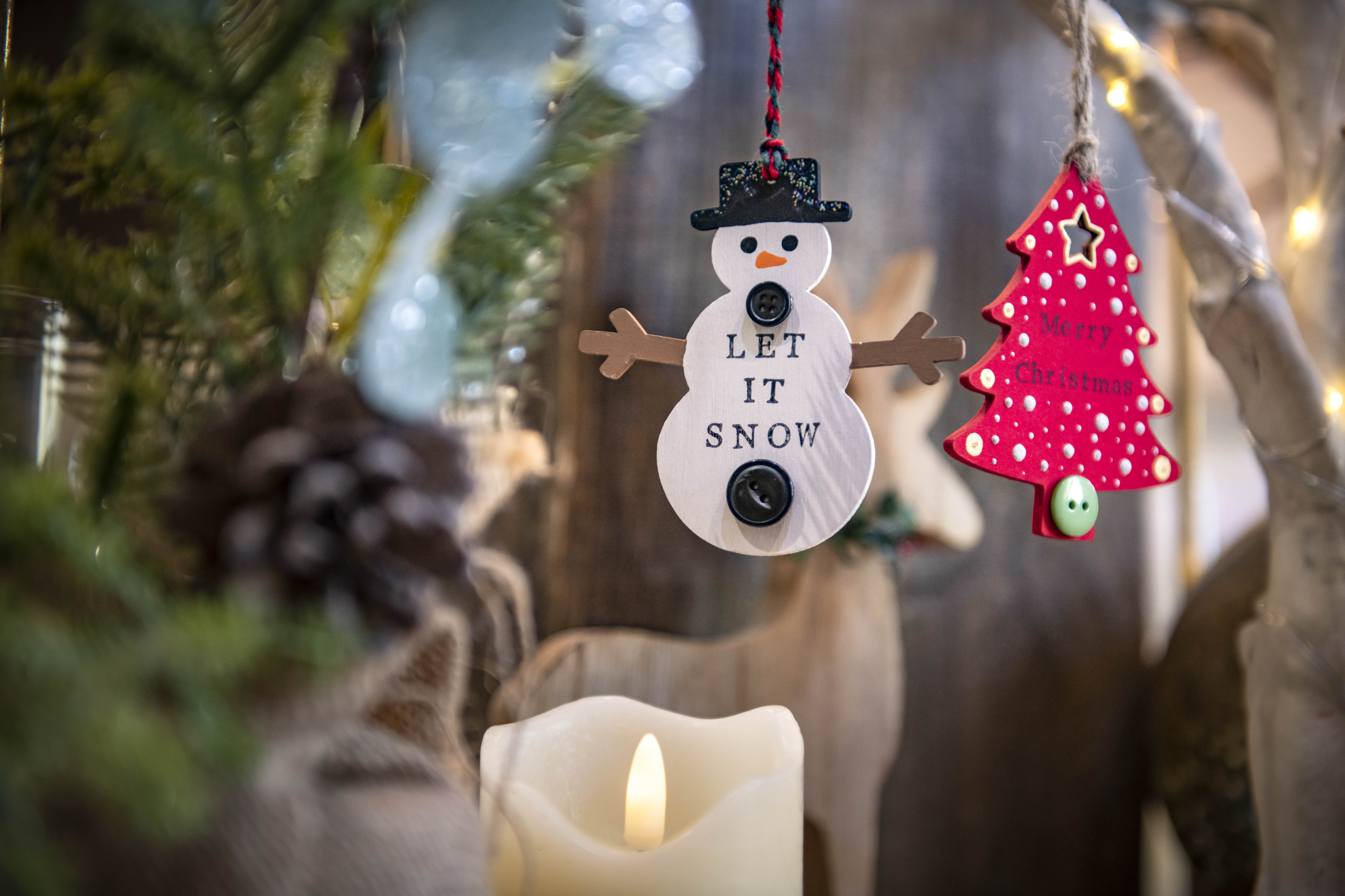 A snowman decoration with the words let it snow