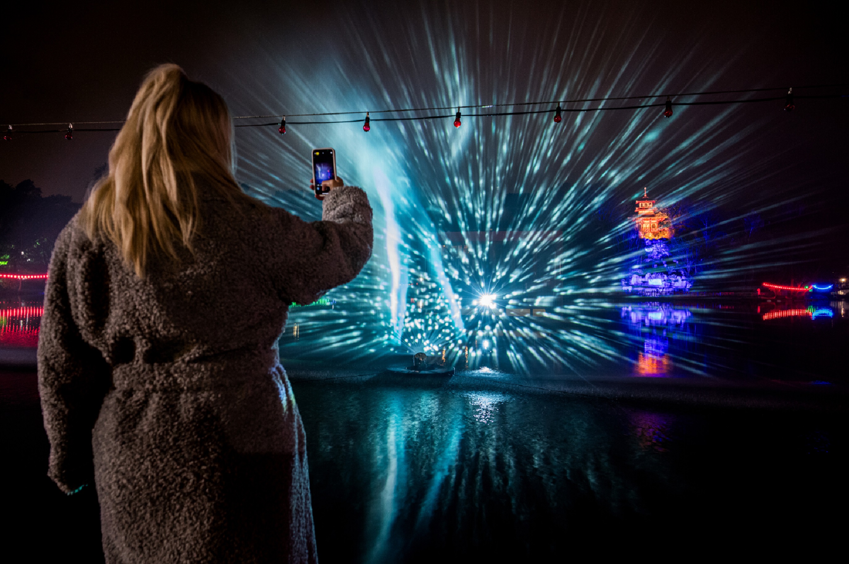 A visitor to Peasholm Park is pictured taking a photograph of the illuminated artworks as part of the Scarborough Lights festival. 