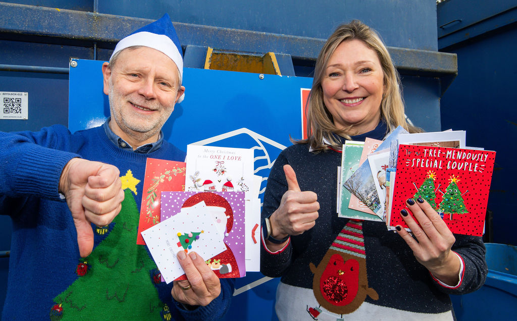 Two people with Christmas cards