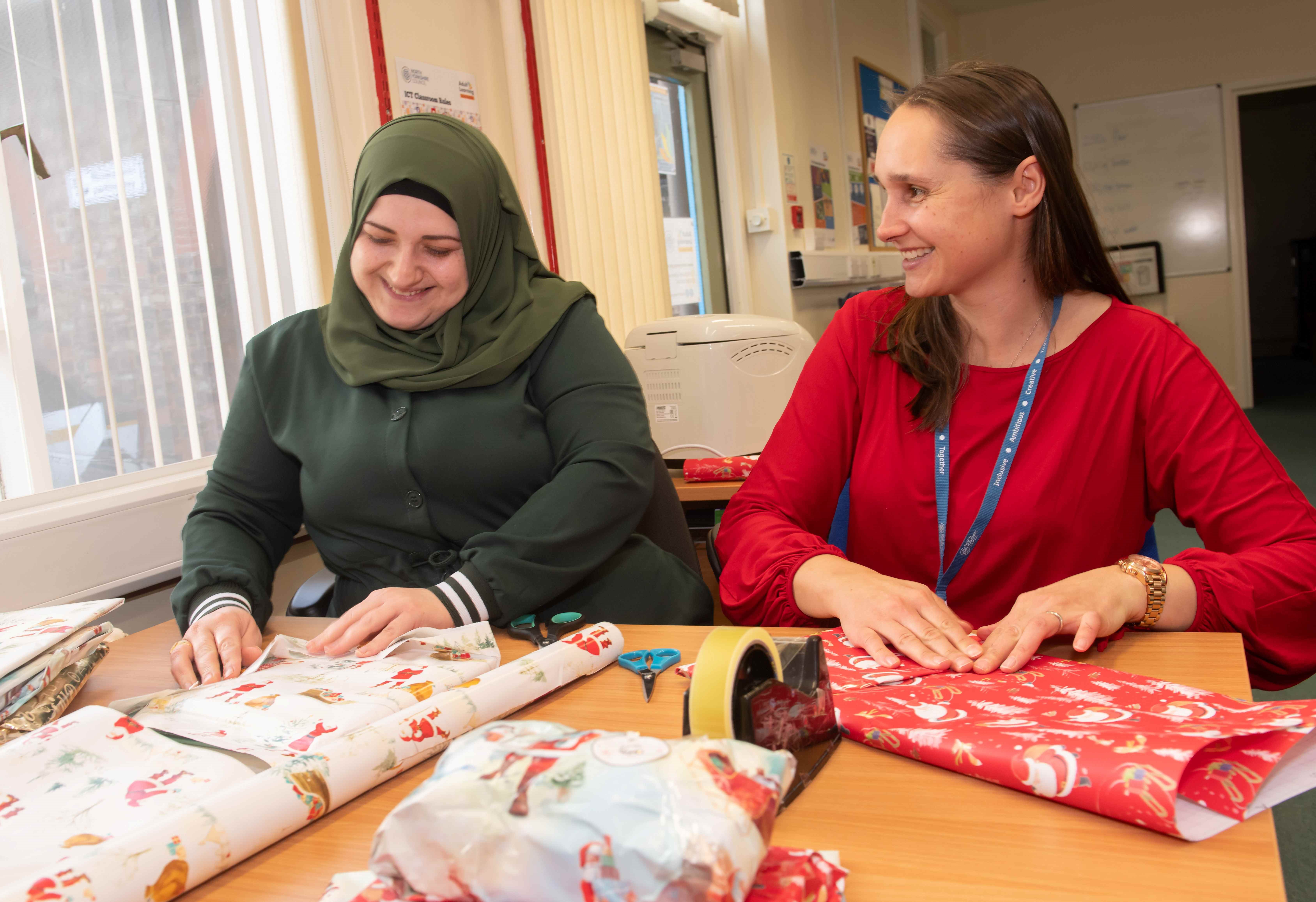 Ivana Gardner with learner Fatima spreading festive cheer for local asylum seekers.