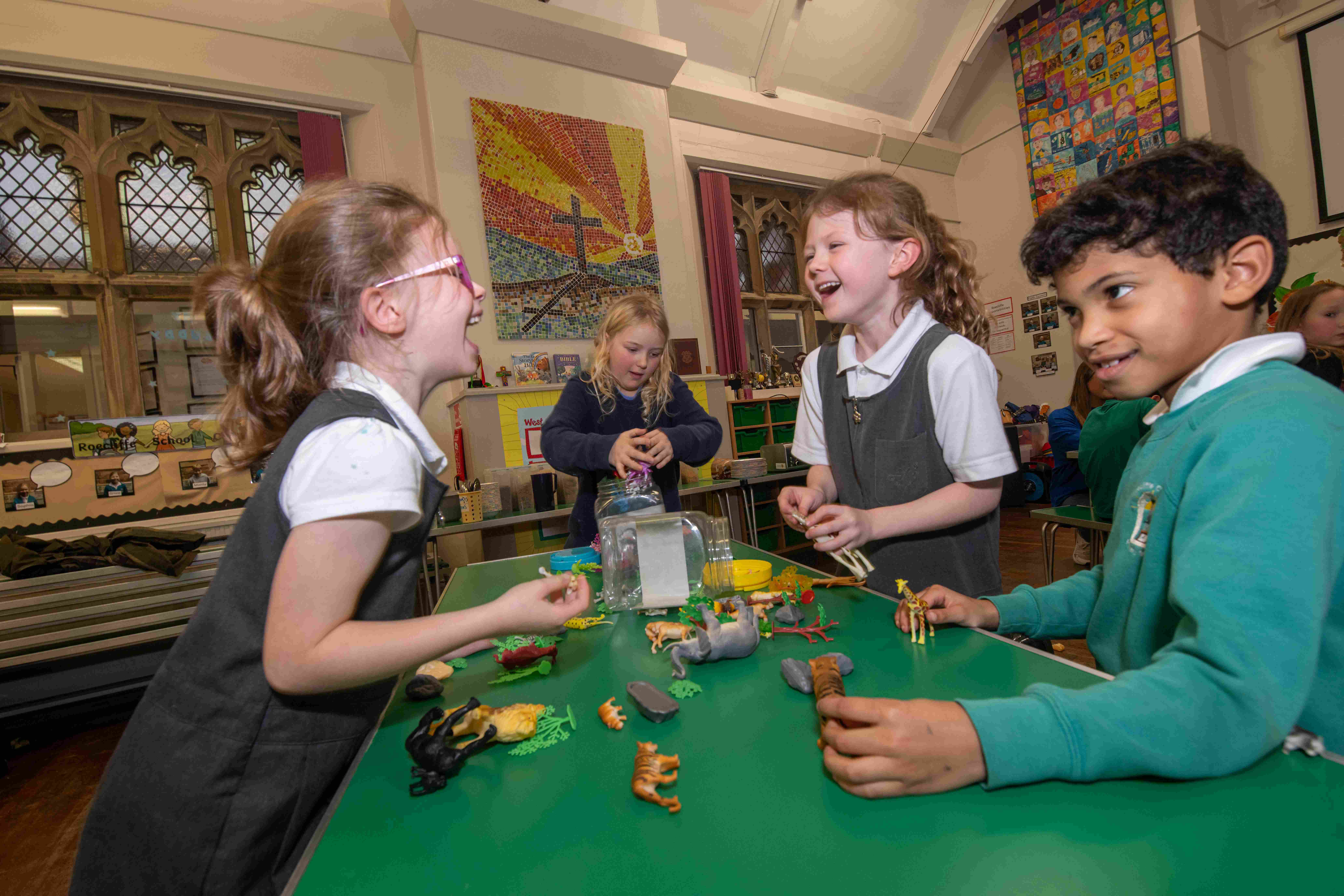 Four children at a childcare setting laughing