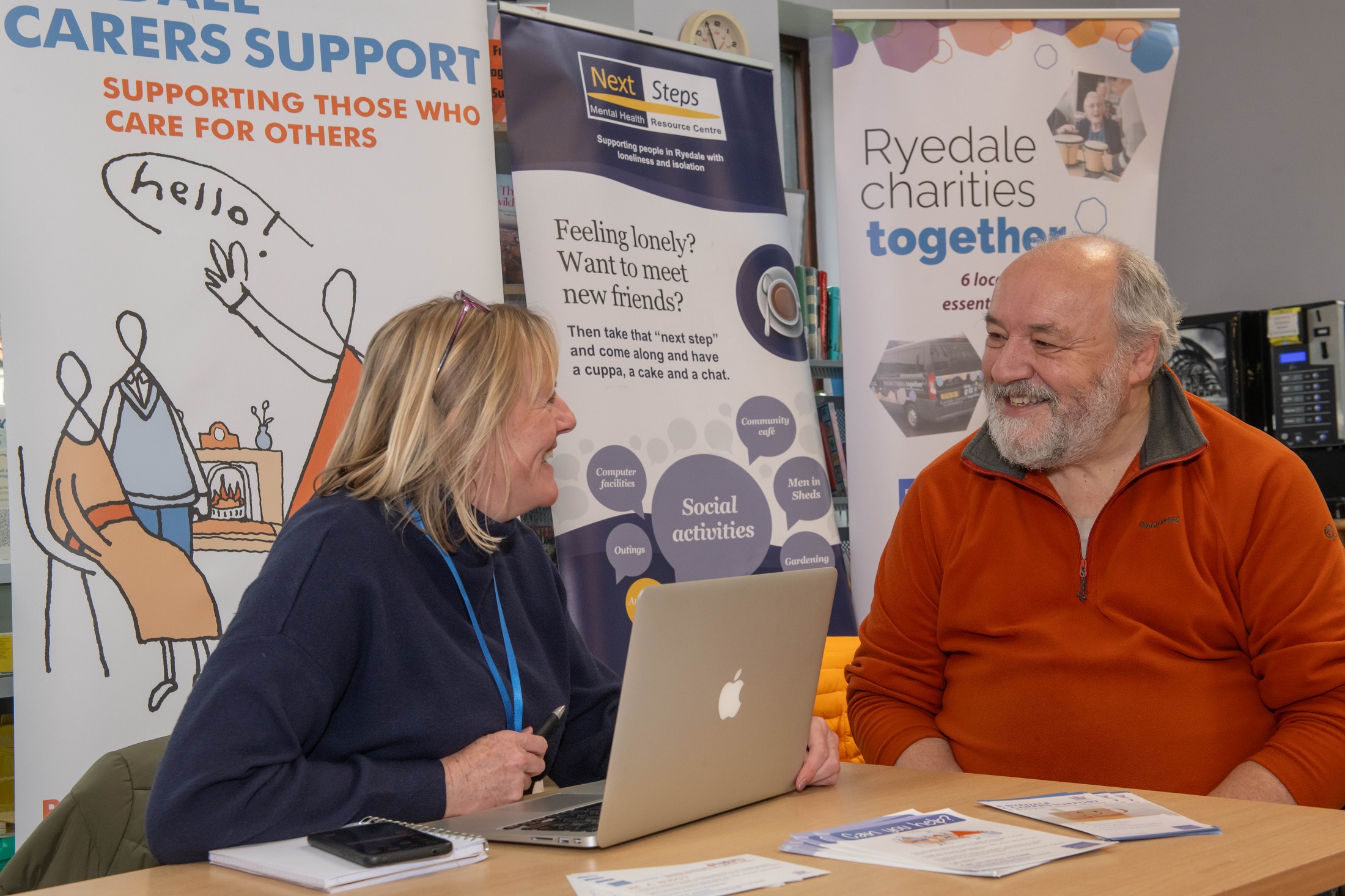 Heather Witty, Ryedale Carers Support coordinator, chatting to library visitor David Swann about the services on offer.