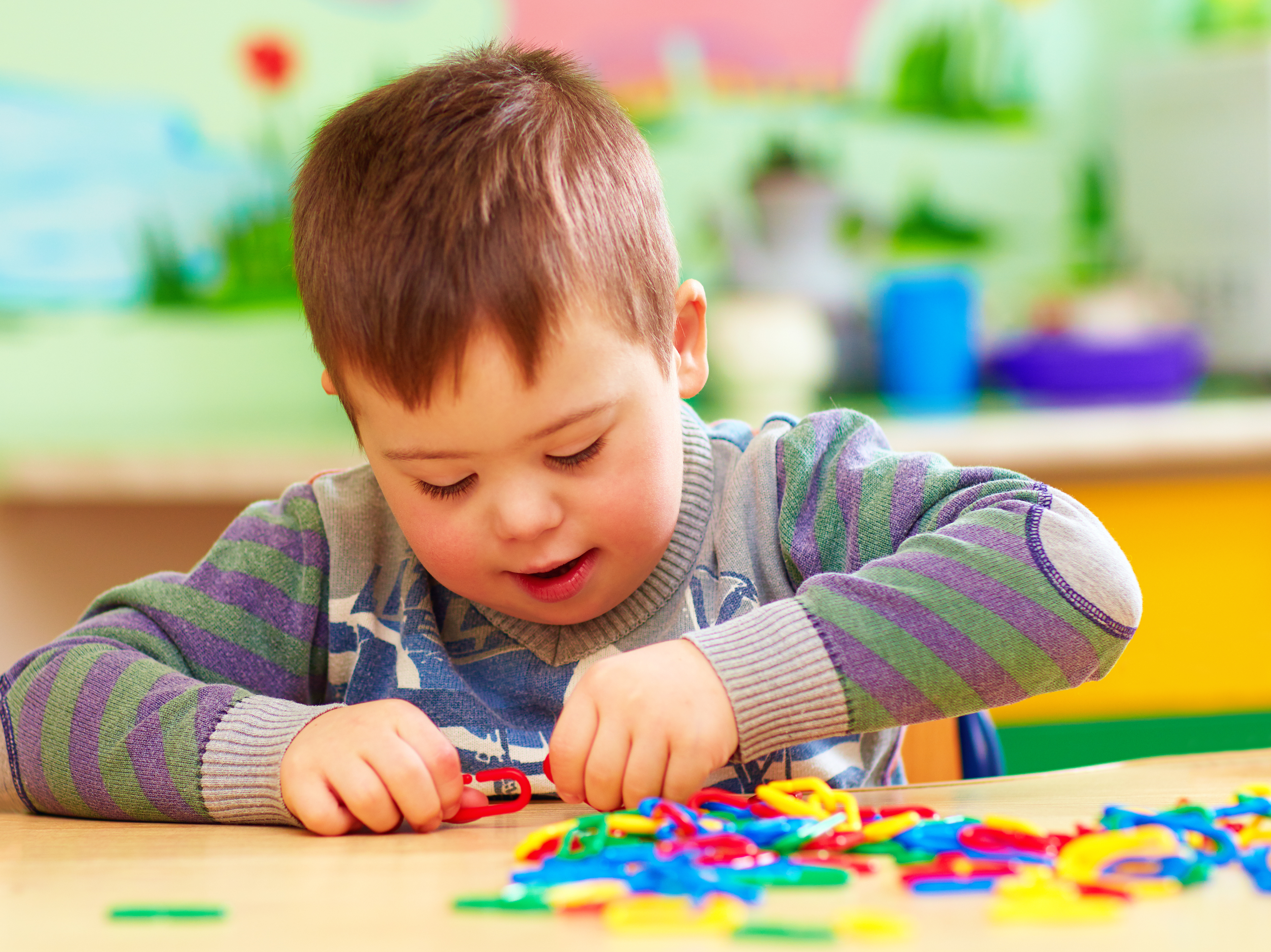 A young boy with  bright coloured clips