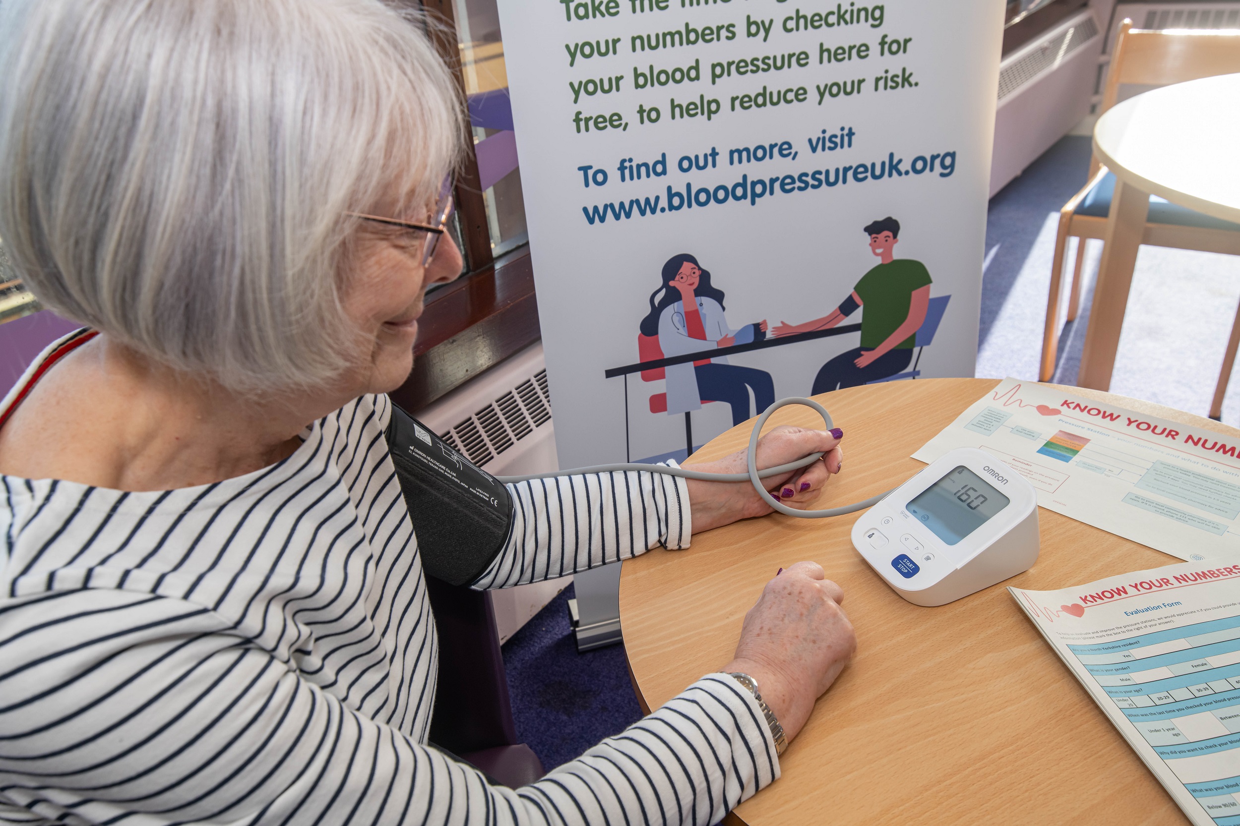 A lady getting her blood pressure checked