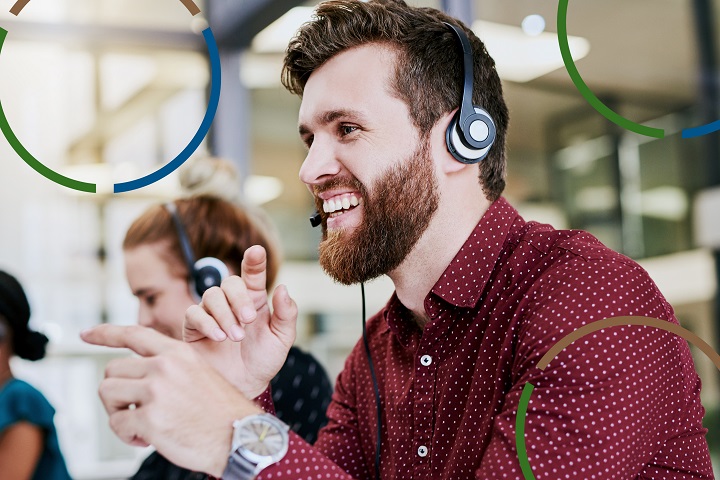 Man with a headset looking at computer